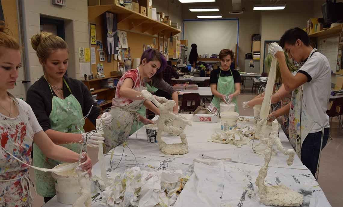 students creating sculptures